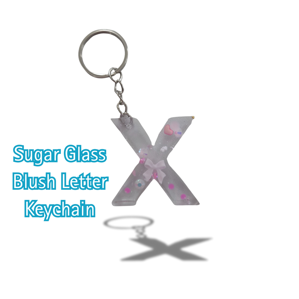 Letter 'X' keychain with sugar glass blush finish on a white background