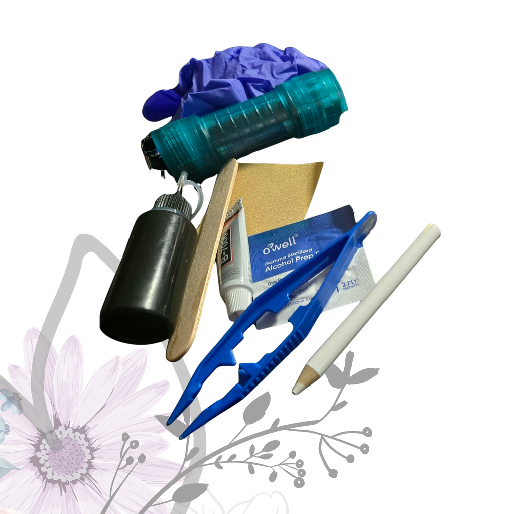Collection of items including a blue tool, black container, and other small objects on a white background with floral design.
